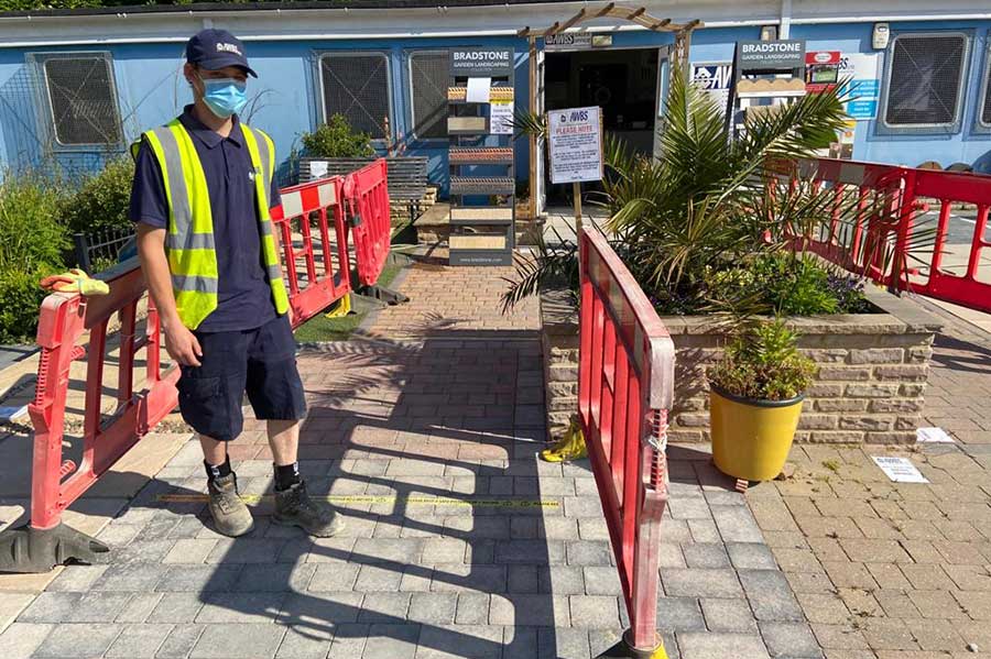 AWBS memeber of staff in PPE controlling visitor numbers in branch at Swindon